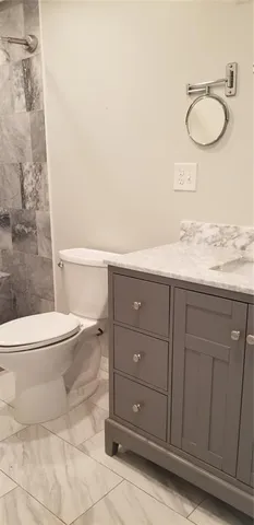 a bathroom with a sink vanity and mirror