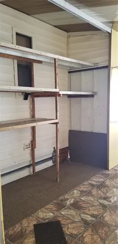 a view of an empty room with a cabinet