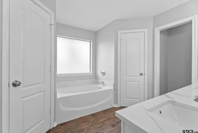 a bathroom with a bathtub and a shower