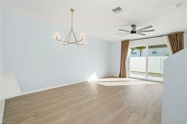 a view of a room with wooden floor and white walls