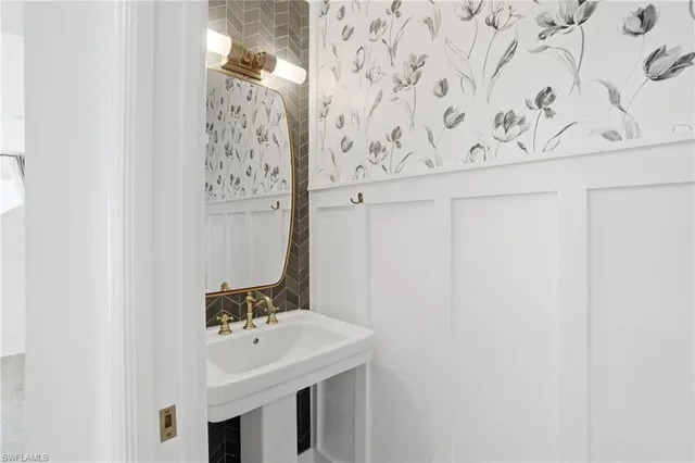 an empty room with wooden floor cabinet and windows