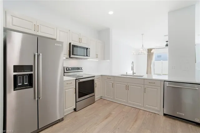 a view of a room with wooden floor ceiling fan and window