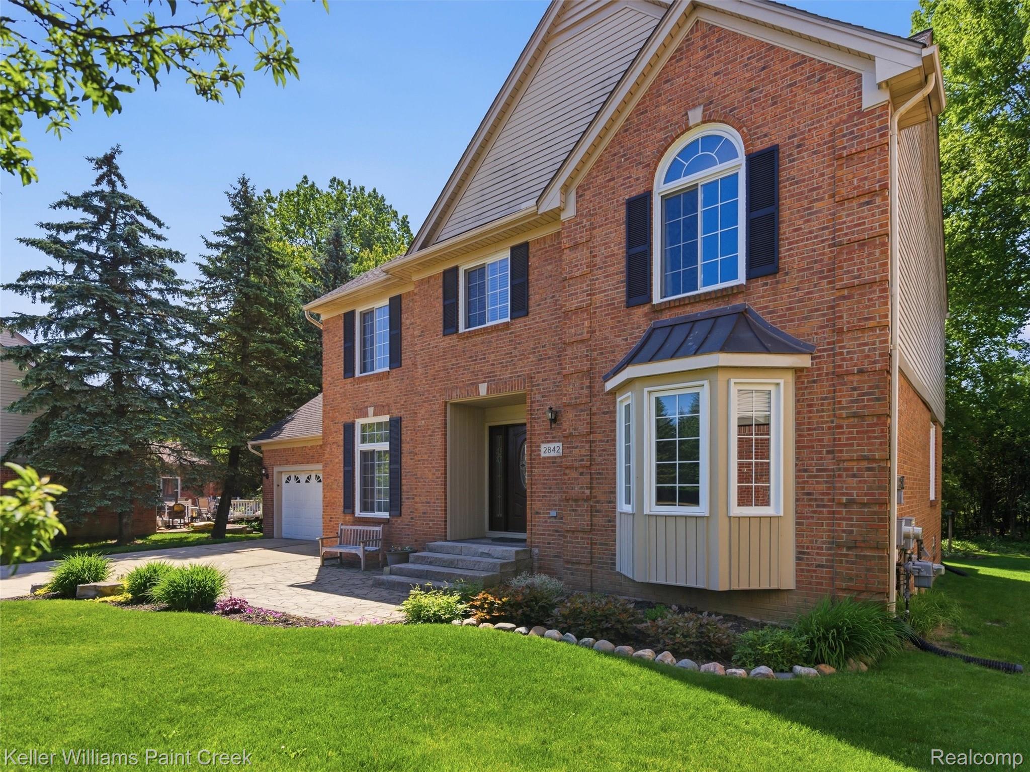 2842 Manorwood Road Troy, MI 48085 - Photo 6 of 72 Brick exterior with a prominent arched window and dark shutters