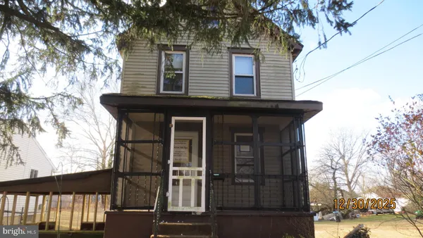 a view of a house with a tree