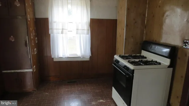 a kitchen with a stove and a refrigerator