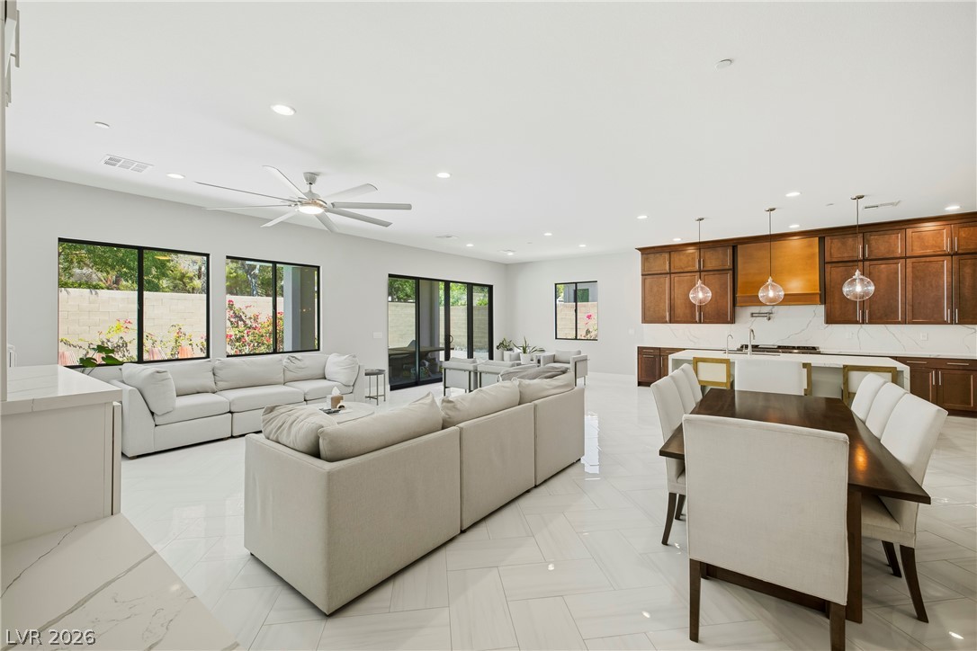 45 Garibaldi Way Henderson, NV 89011 - Photo 18 of 74 An open-concept great room offers high ceilings, seamless tile flooring, and abundant natural light.
