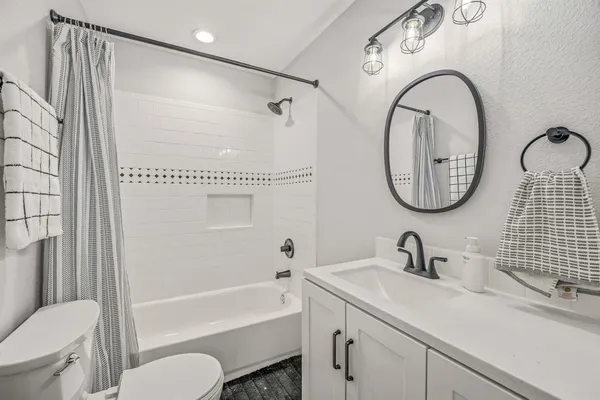 a bathroom with a toilet a sink and a mirror