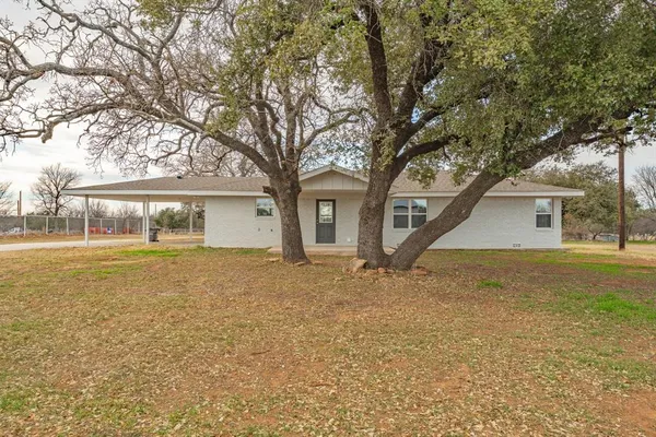 a house with trees in the background