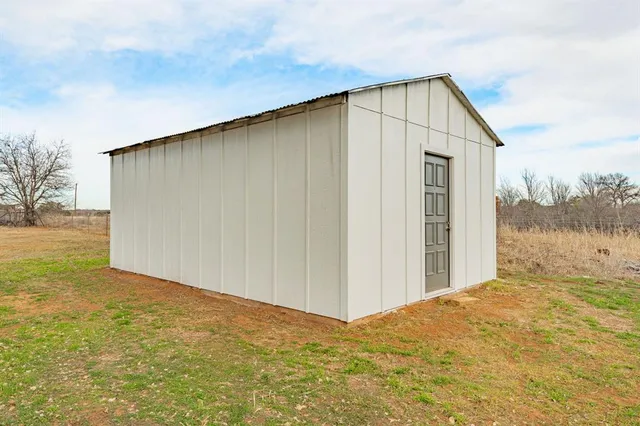 a view of an empty room with floor to ceiling window