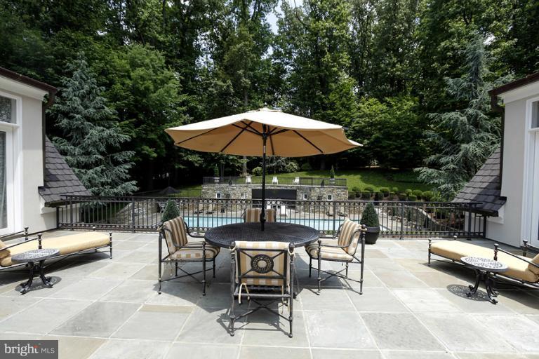 11218 River View Drive Potomac, MD 20854 - Photo 2 of 24 a view of backyard with outdoor seating and trees