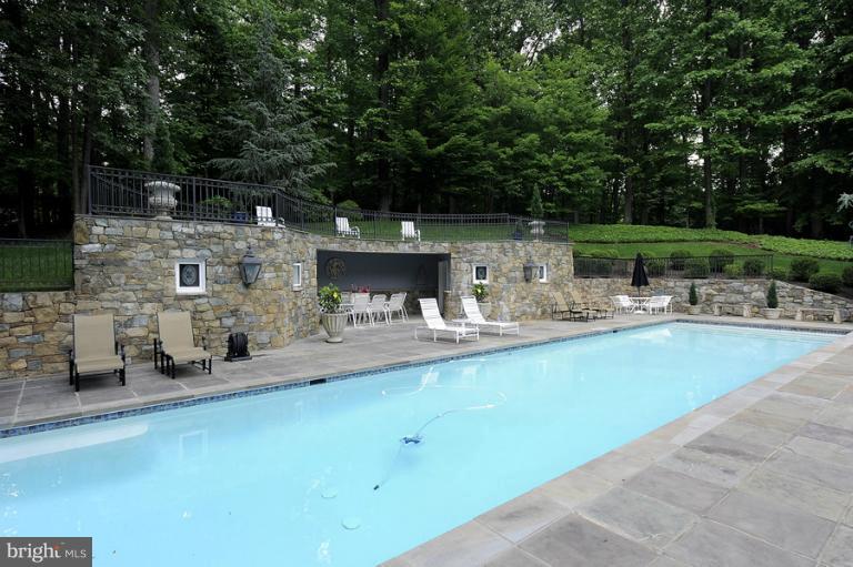 11218 River View Drive Potomac, MD 20854 - Photo 18 of 24 a swimming pool with outdoor seating and yard
