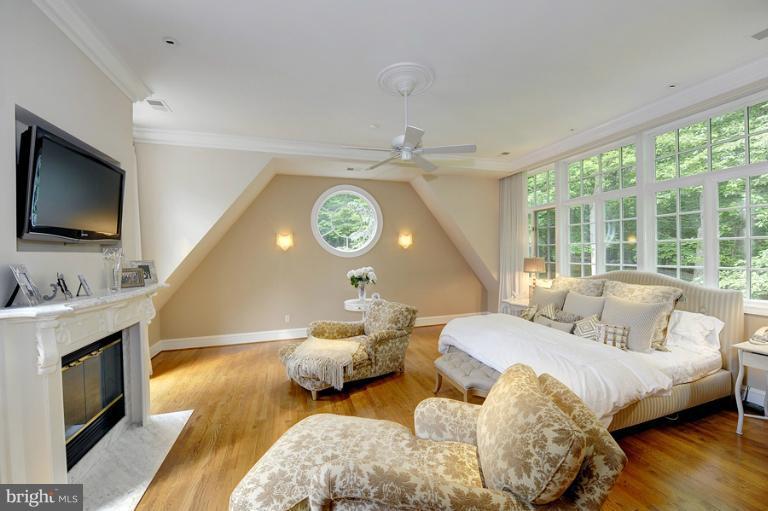 11218 River View Drive Potomac, MD 20854 - Photo 8 of 24 a bedroom with furniture and a flat screen tv