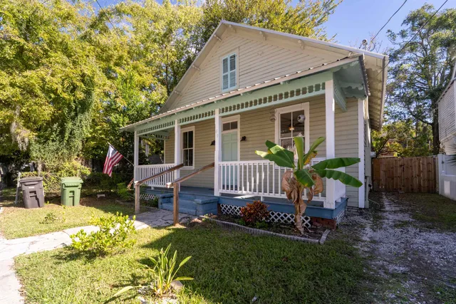 a front view of a house with a garden and porch