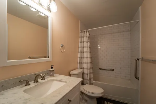 a bathroom with a sink toilet and shower