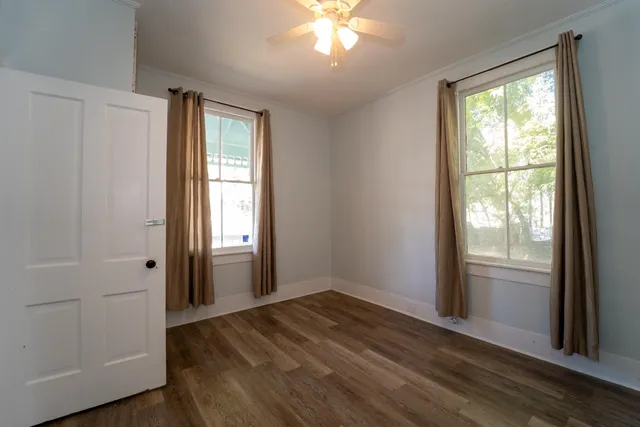wooden floor in an empty room with a window