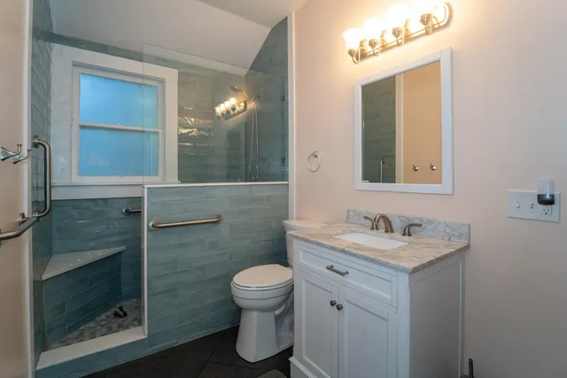 a bathroom with a toilet sink and mirror