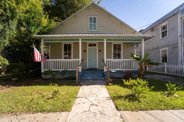 a front view of a house with a garden and patio