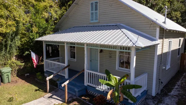 a front view of a house with garden
