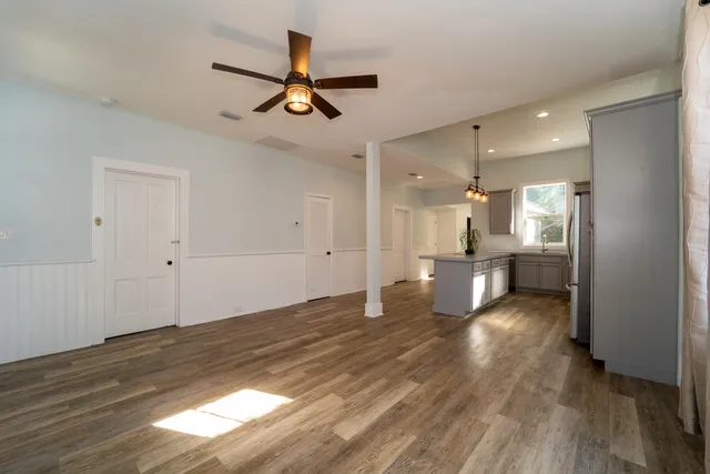 a view of a kitchen with a sink and wooden floor