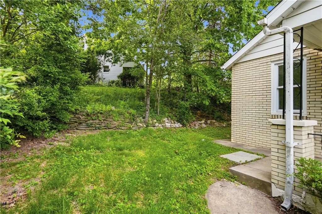 480 Songo Street Pittsburgh, PA 15227 - Photo 31 of 36 a backyard of a house with plants and large tree