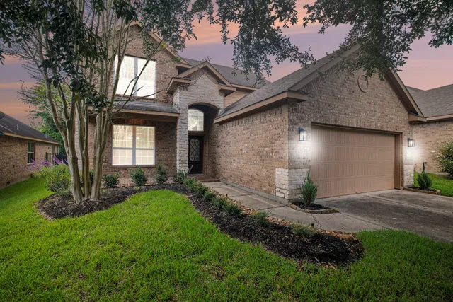 a front view of a house with a yard and outdoor seating