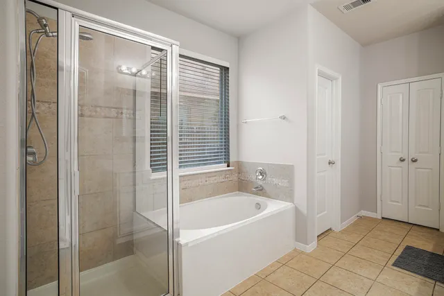 a bathroom with a bathtub and shower