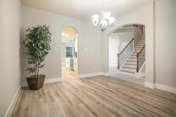 a view of a livingroom with wooden floor and staircase