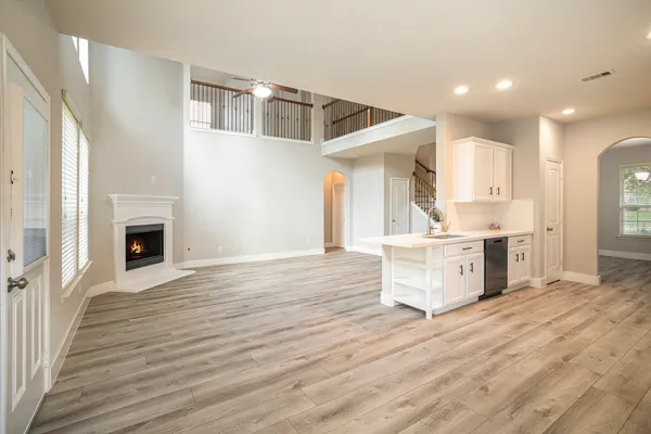 a view of kitchen and kitchen with granite countertop wooden floor