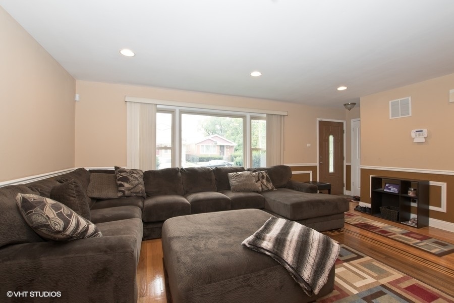 2605 West 83rd Place Chicago, IL 60652 - Photo 2 of 14 a living room with furniture window and a fireplace