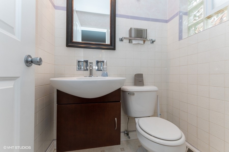 2605 West 83rd Place Chicago, IL 60652 - Photo 13 of 14 a bathroom with a toilet sink vanity and mirror