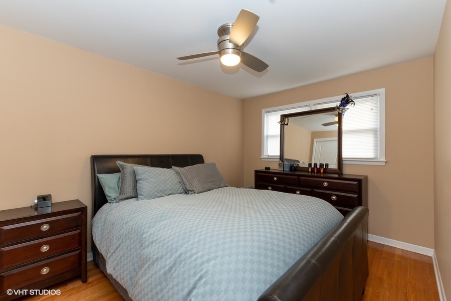 2605 West 83rd Place Chicago, IL 60652 - Photo 8 of 14 a bedroom with a bed and a chandelier