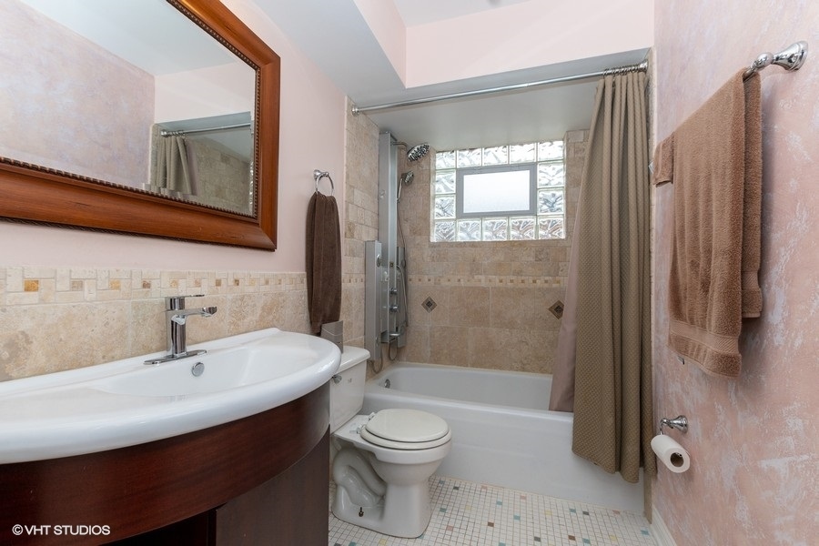 2605 West 83rd Place Chicago, IL 60652 - Photo 10 of 14 a bathroom with a sink a toilet and shower