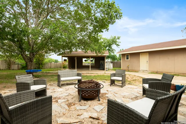 a view of a patio with couches chairs and a fire pit
