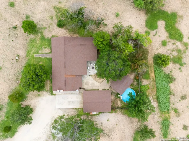an aerial view of a house with a yard and a garden