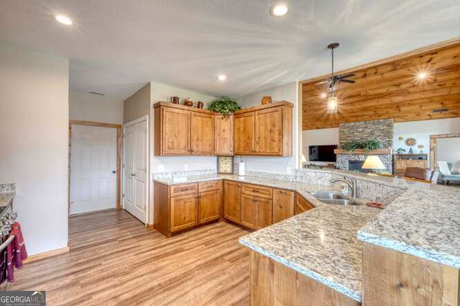 85 Minstead Ridge Young Harris, GA 30582 - Photo 15 of 50 a large kitchen with stainless steel appliances kitchen island granite countertop a sink and cabinets