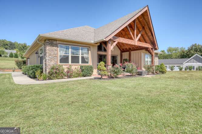 85 Minstead Ridge Young Harris, GA 30582 - Photo 17 of 50 a front view of house with yard and trees around