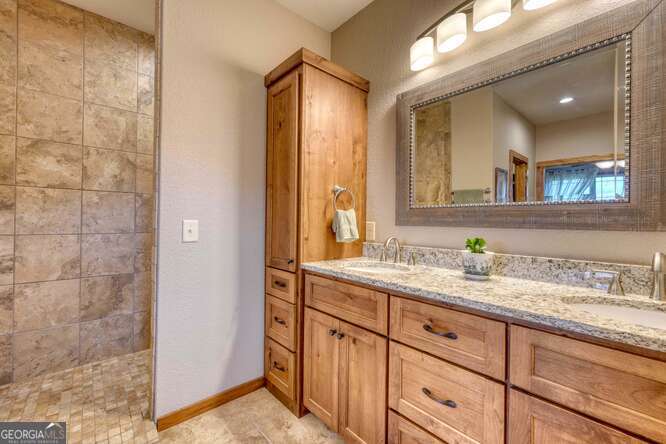 85 Minstead Ridge Young Harris, GA 30582 - Photo 25 of 50 a bathroom with a granite countertop sink mirror and double