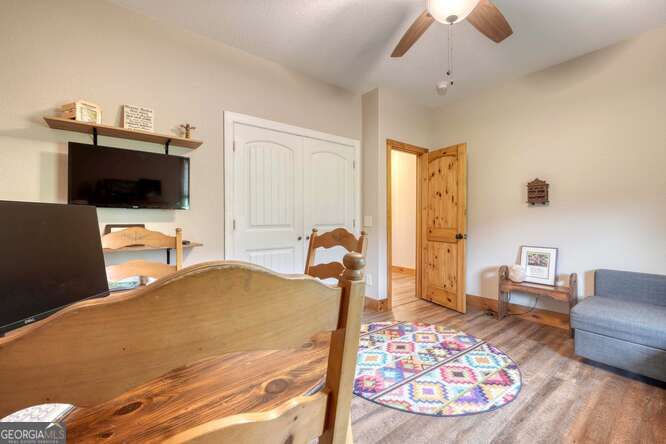 85 Minstead Ridge Young Harris, GA 30582 - Photo 30 of 50 a bedroom with a bed and wooden floor