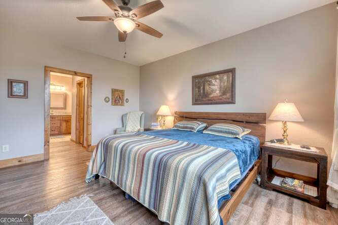 85 Minstead Ridge Young Harris, GA 30582 - Photo 34 of 50 a bedroom with a bed and a lamp