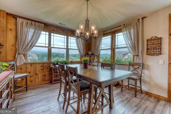 85 Minstead Ridge Young Harris, GA 30582 - Photo 35 of 50 a view of a dining room with furniture large windows and wooden floor