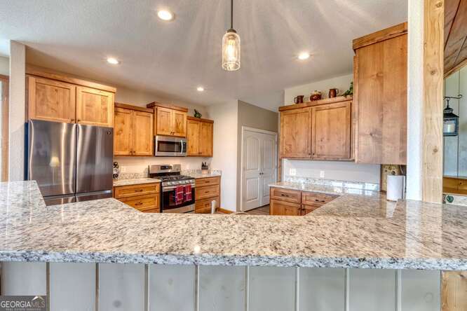 85 Minstead Ridge Young Harris, GA 30582 - Photo 50 of 50 a kitchen with stainless steel appliances granite countertop sink stove and refrigerator