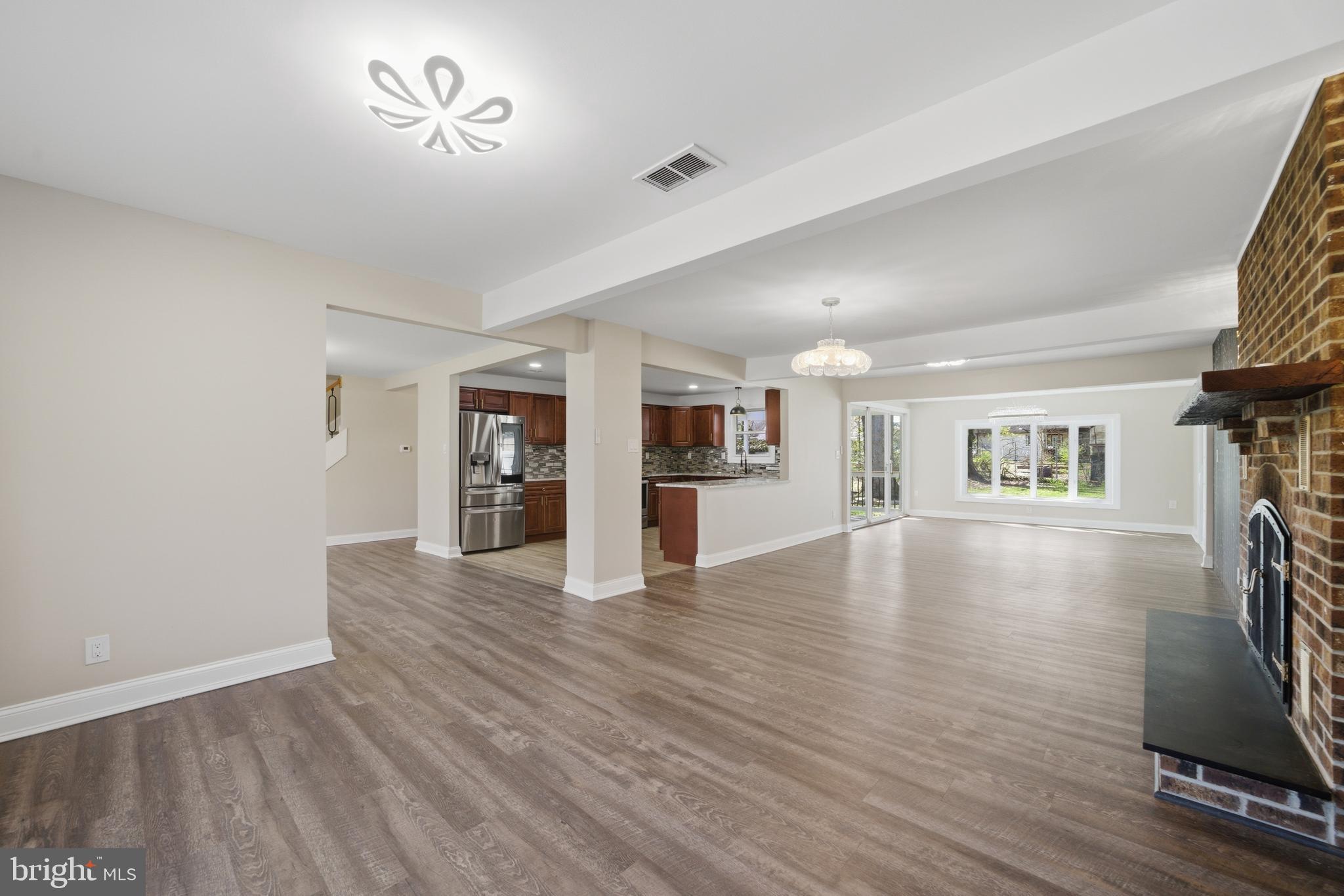 443 High Street Woodbury, NJ 08096 - Photo 11 of 28 a view of empty room with wooden floor and fireplace