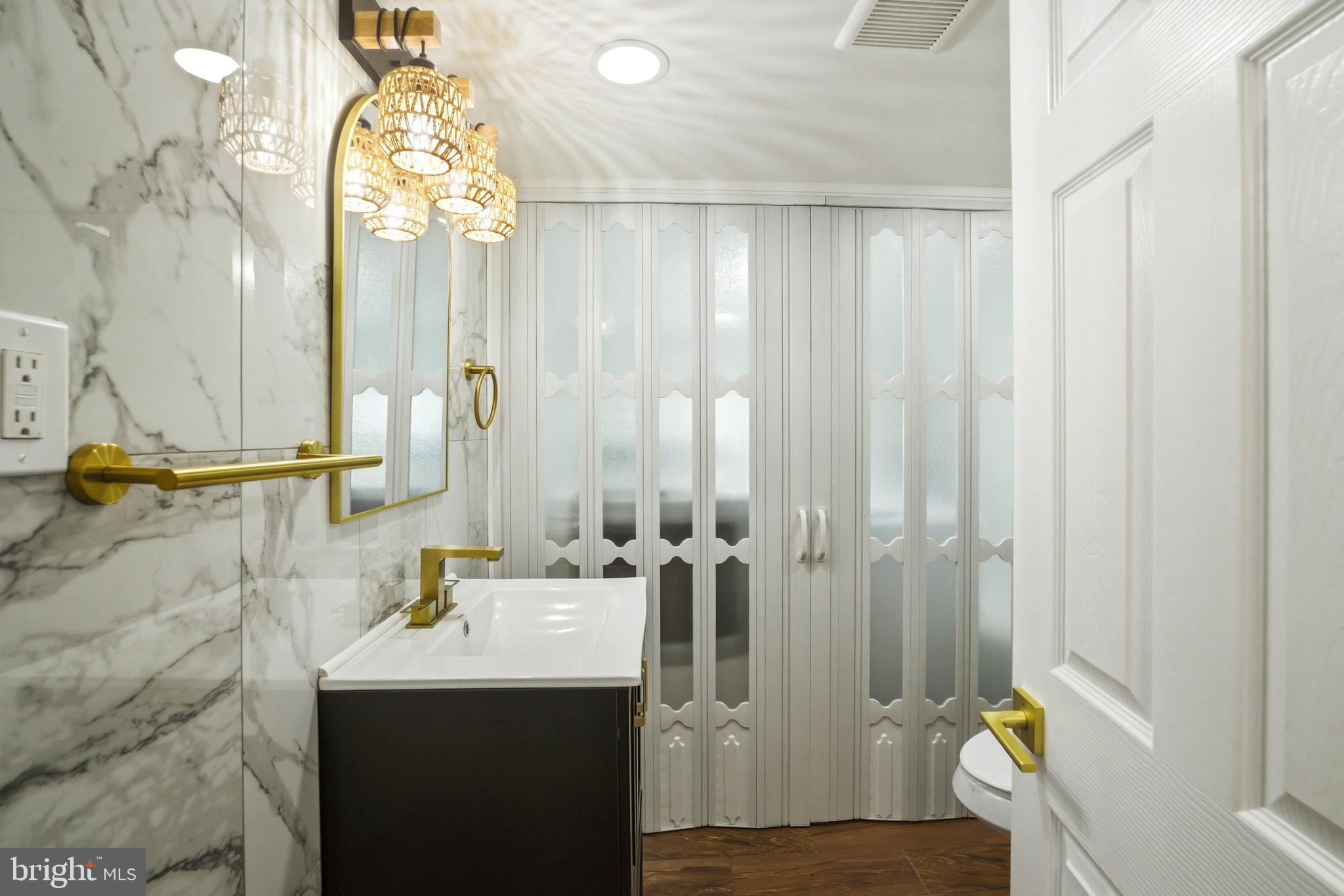 443 High Street Woodbury, NJ 08096 - Photo 21 of 28 a bathroom with a granite countertop sink a mirror and a shower