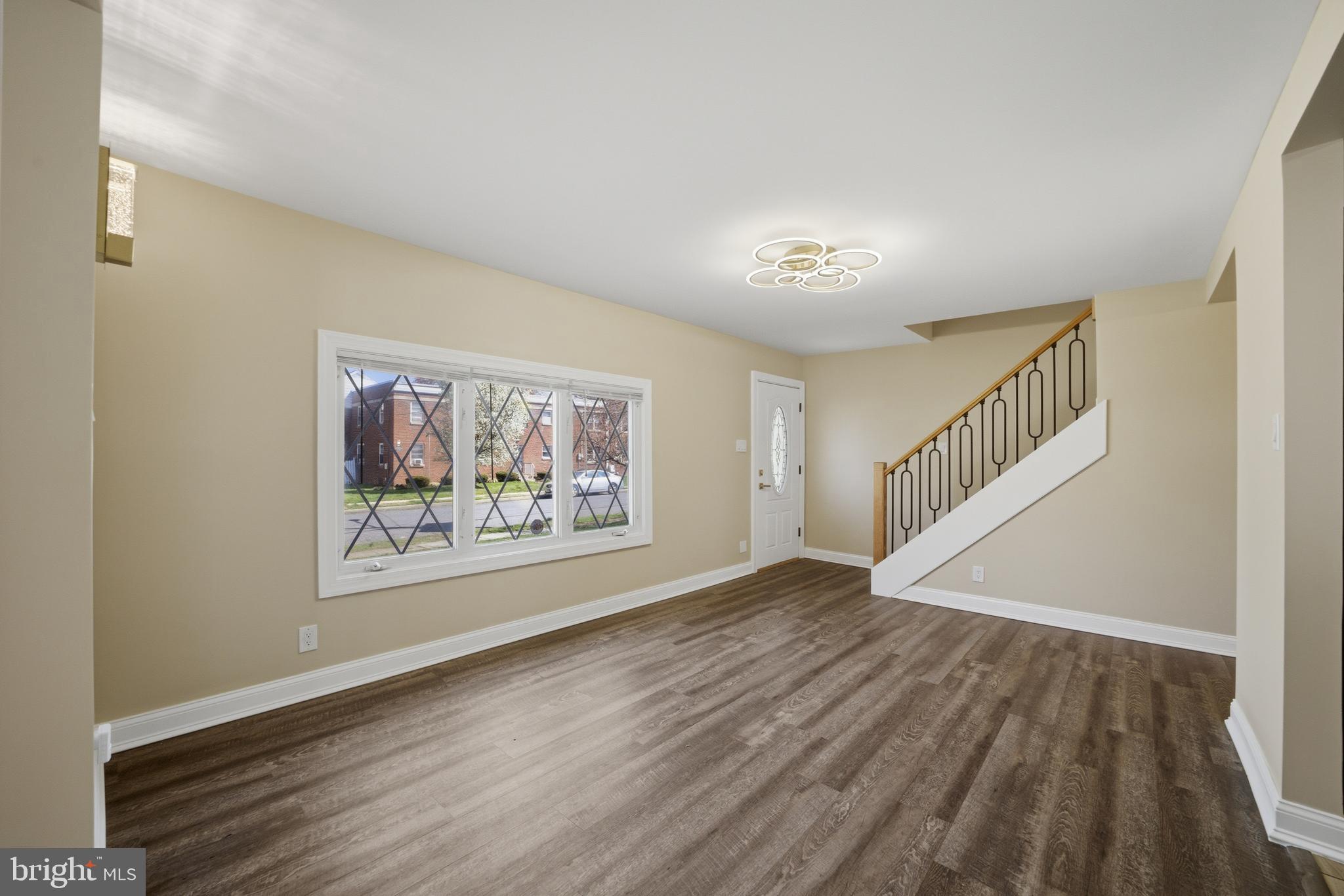 443 High Street Woodbury, NJ 08096 - Photo 6 of 28 a view of an empty room with wooden floor and a window