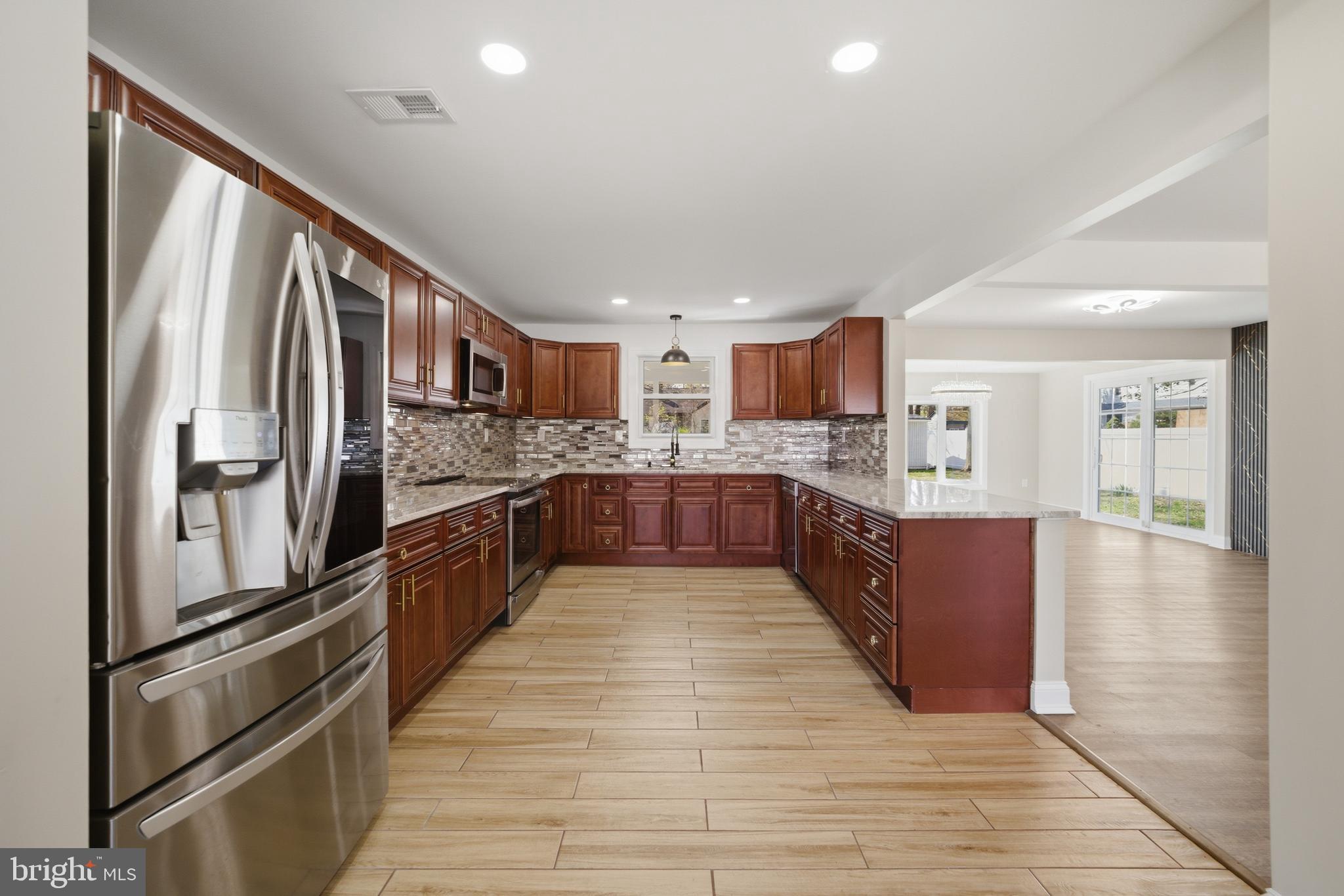 443 High Street Woodbury, NJ 08096 - Photo 7 of 28 a large kitchen with stainless steel appliances kitchen island granite countertop a large counter top stainless steel appliances and cabinets