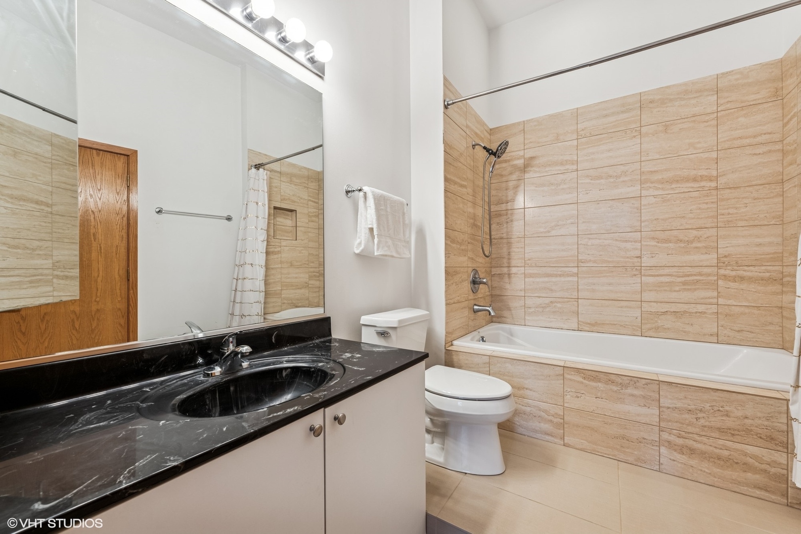 910 South Michigan Avenue, Unit 710 Chicago, IL 60605 - Photo 11 of 17 a bathroom with a sink and a mirror