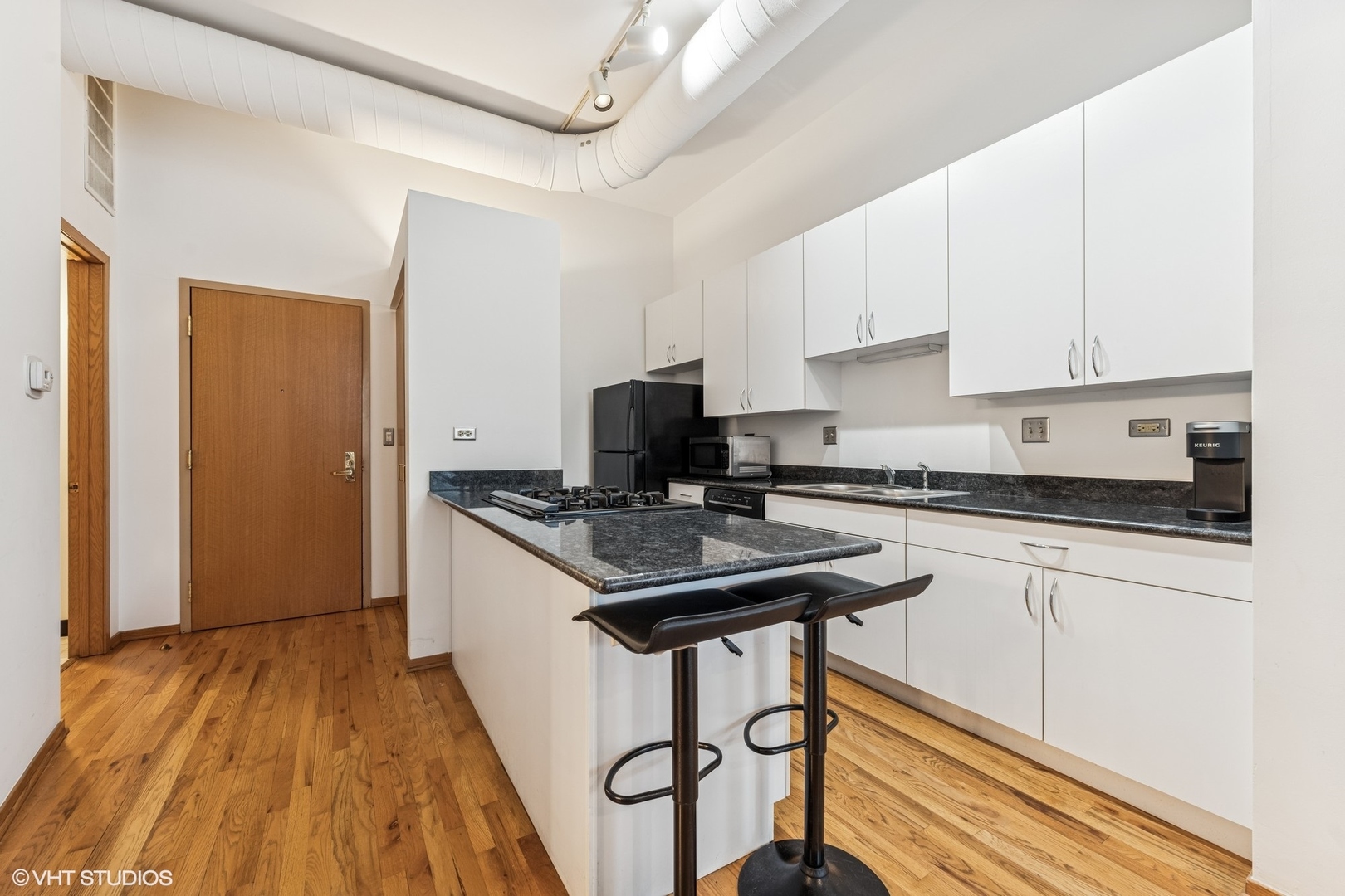 910 South Michigan Avenue, Unit 710 Chicago, IL 60605 - Photo 4 of 17 a kitchen with stainless steel appliances granite countertop a stove and a refrigerator