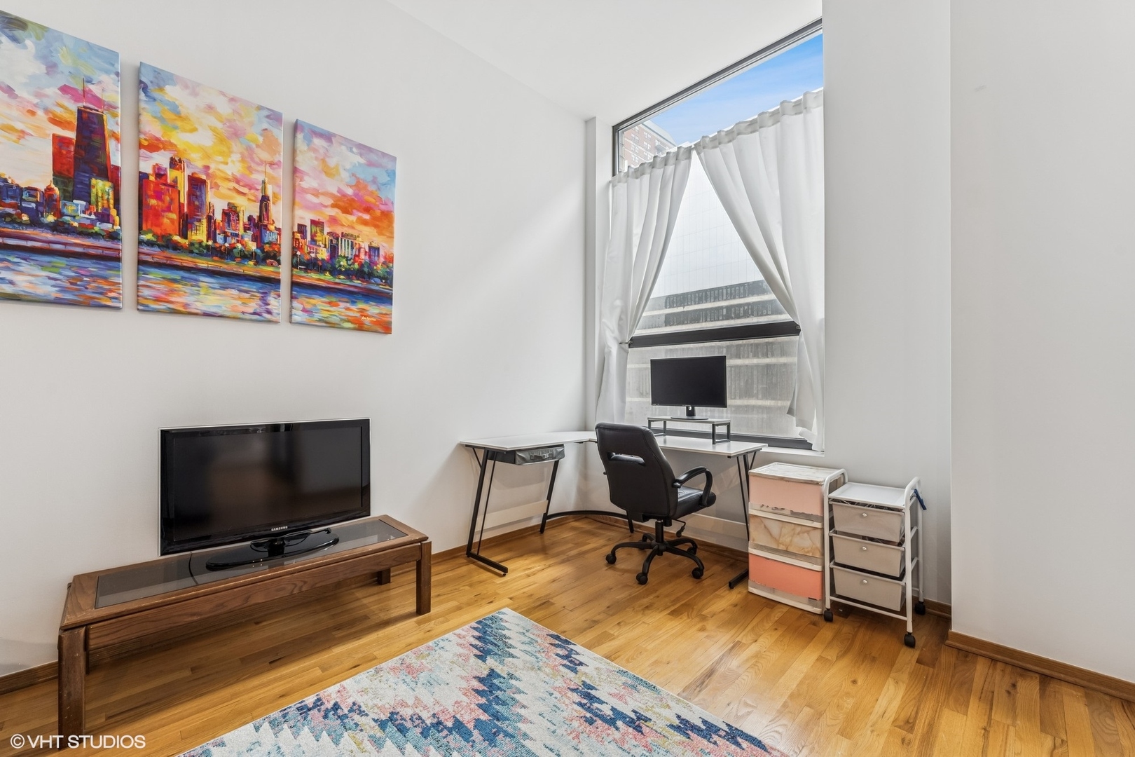 910 South Michigan Avenue, Unit 710 Chicago, IL 60605 - Photo 6 of 17 a living room with furniture and a flat screen tv