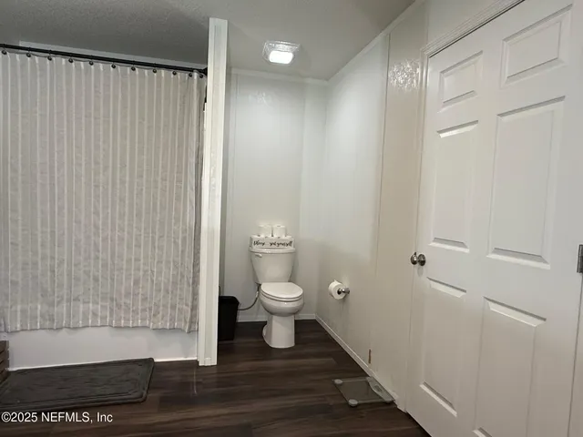 a bathroom with a toilet and a shower
