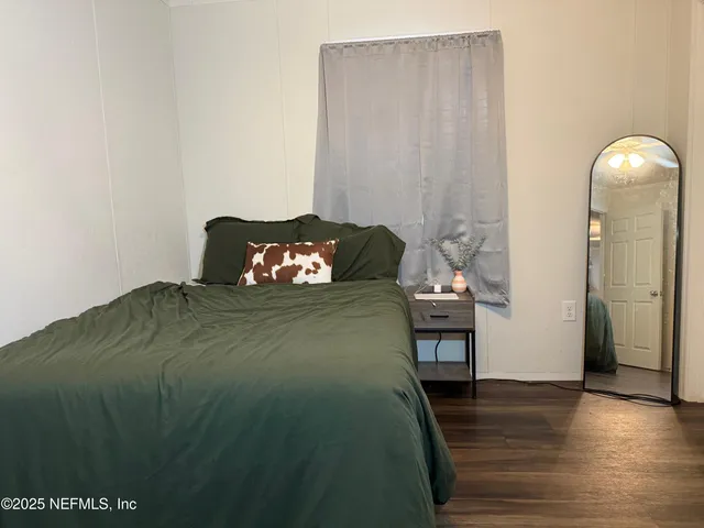 a bed sitting in a bedroom next to a window